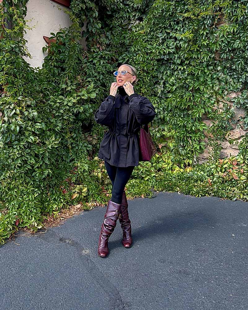 revolve black zip up jacket with adjustable waist worn by Eve Dawes with black leggings